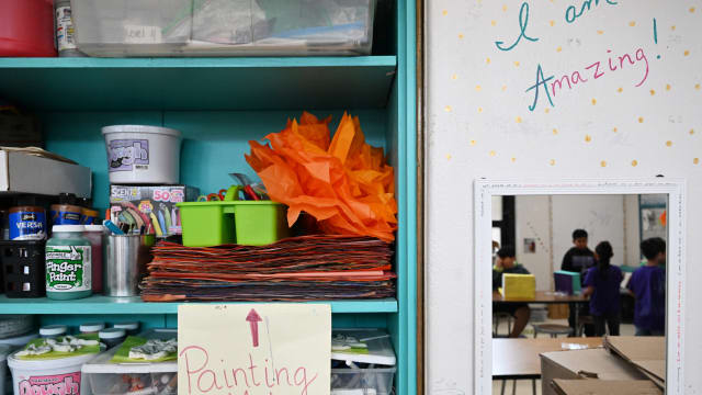 A picture of a cabinet filled with classroom art supplies.