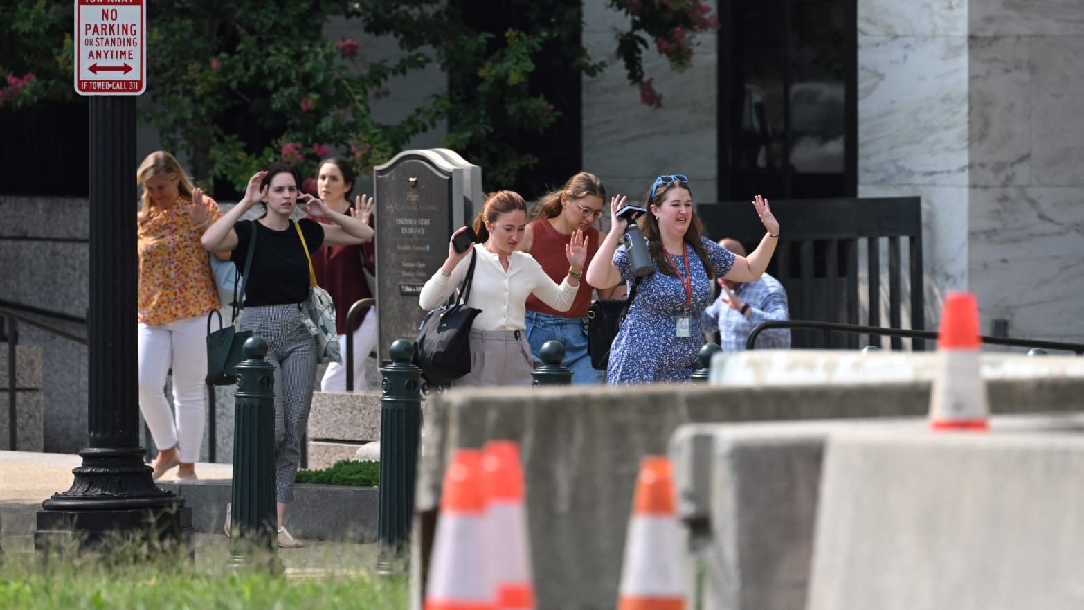 People walk out of the Russell Senate Office Building after unconfirmed reports of an active shooter.