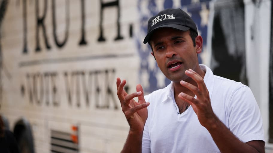 Republican presidential candidate Vivek Ramaswamy answers questions from reporters beside his campaign bus in Contoocook, New Hampshire.