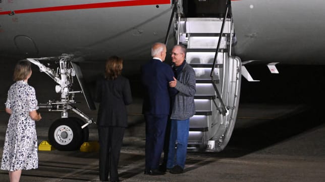 US President Joe Biden and Vice President Kamala Harris welcome former prisoner held by Russia, ex-US Marine Paul Whelan, as he arrives at Joint Base Andrews in Maryland on August 1, 2024. 