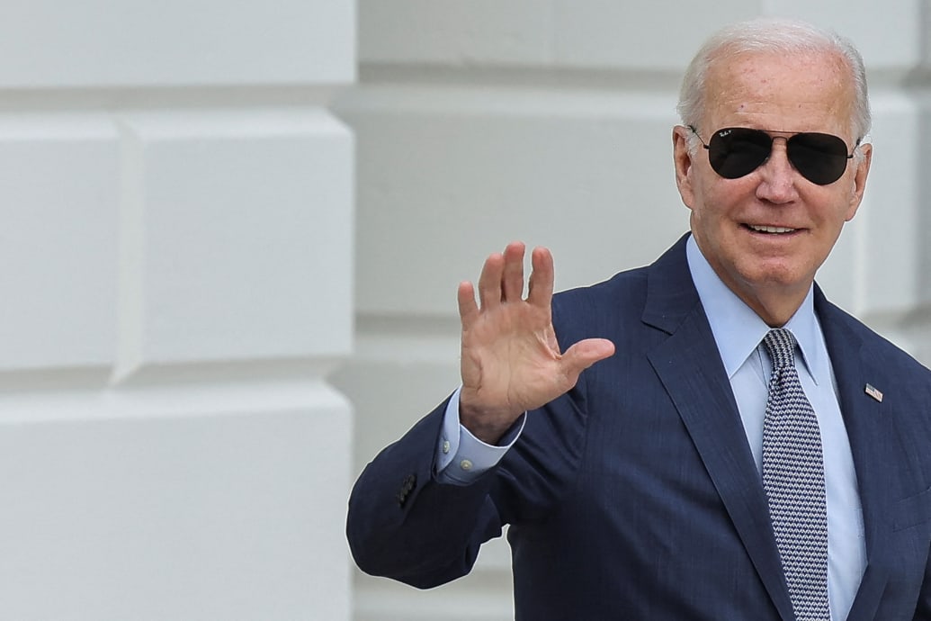 U.S. President Joe Biden waves as he walks to board Marine One for Delaware from the White House