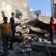 Palestinians inspect a house destroyed in an Israeli strike, amid the ongoing conflict between Israel and the Palestinian Islamist group Hamas, in Khan Younis, in the southern Gaza Strip, December 4, 2023. 