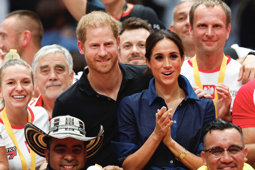 Britain's Prince Harry, Duke of Sussex and his wife Meghan, Duchess of Sussex pose with the medalists after the sitting volleyball final at the 2023 Invictus Games.