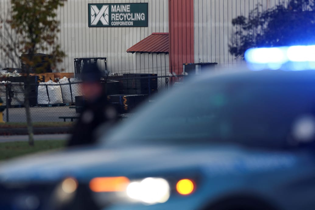 Cop lights flash in front of a Maine Recycling Corporation buillding.