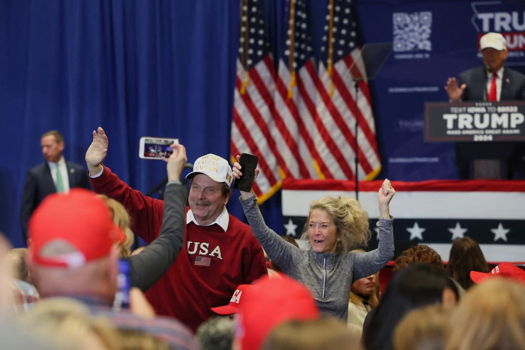 Trump supporters react during the campaign event of former President Donald Trump, in Indianola, Iowa