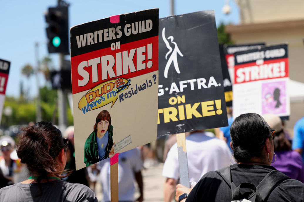 Writers Guild of America protesters march with signs in Los Angeles.
