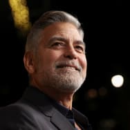 George Clooney smiles at a movie premiere in 2023.