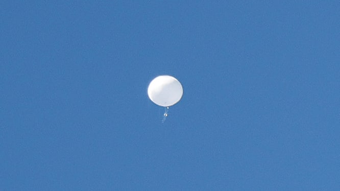 A jet flies by a suspected Chinese spy balloon as it floats off the coast in Surfside Beach, South Carolina, U.S. February 4, 2023.  