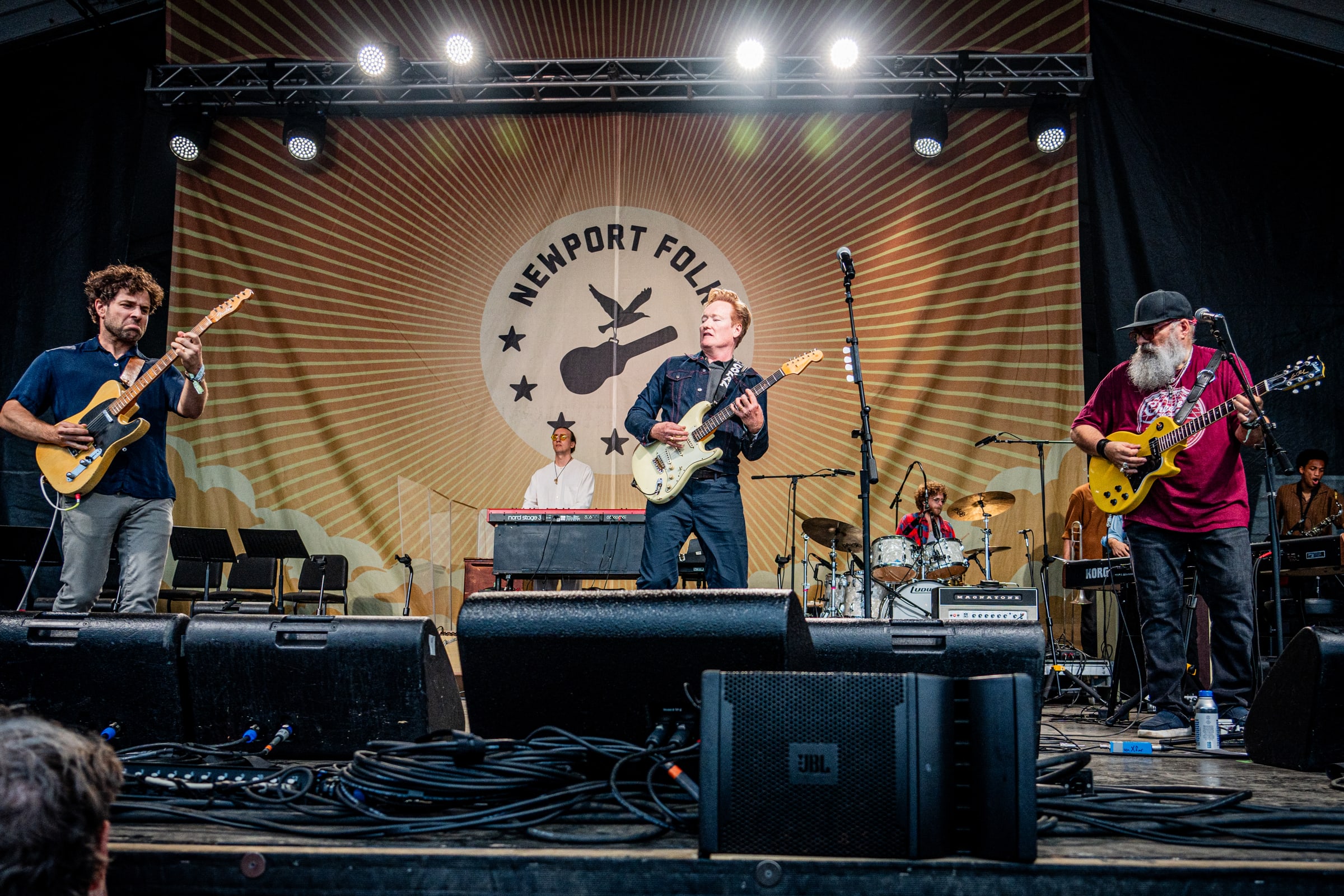 Taylor Goldsmith of Dawes with Conan O'Brien and Jimmy Vivino at Newport Folk Festival