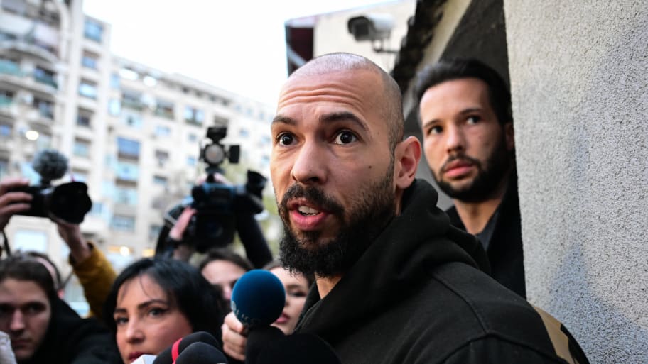 British-US former professional kickboxer and controversial influencer Andrew Tate (front) and his brother Tristan Tate (back R) speak to journalists after having been released from detention in Bucharest, Romania on March 12, 2024,