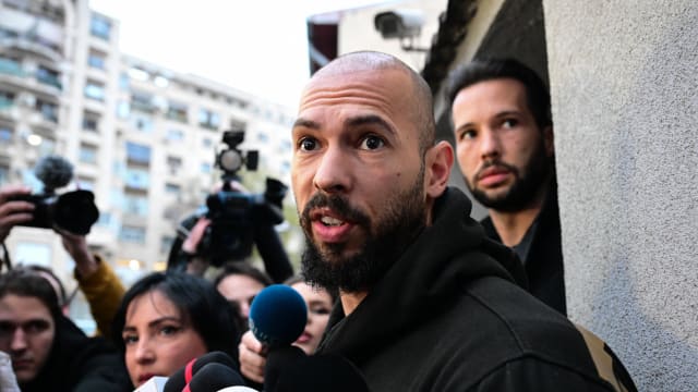 British-US former professional kickboxer and controversial influencer Andrew Tate (front) and his brother Tristan Tate (back R) speak to journalists after having been released from detention in Bucharest, Romania.