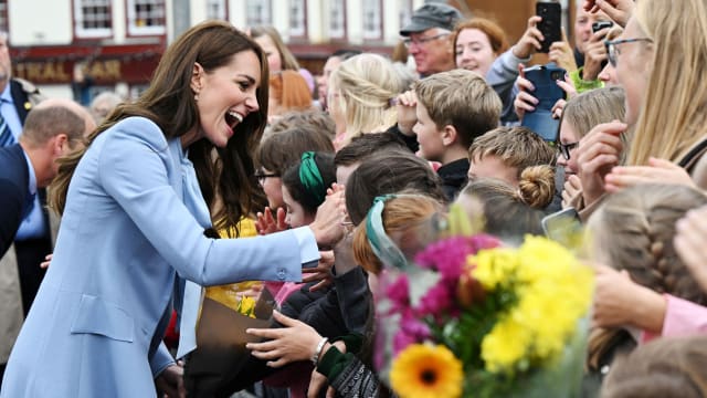 Kate Middleton smiles as she meets with people in Belfast.