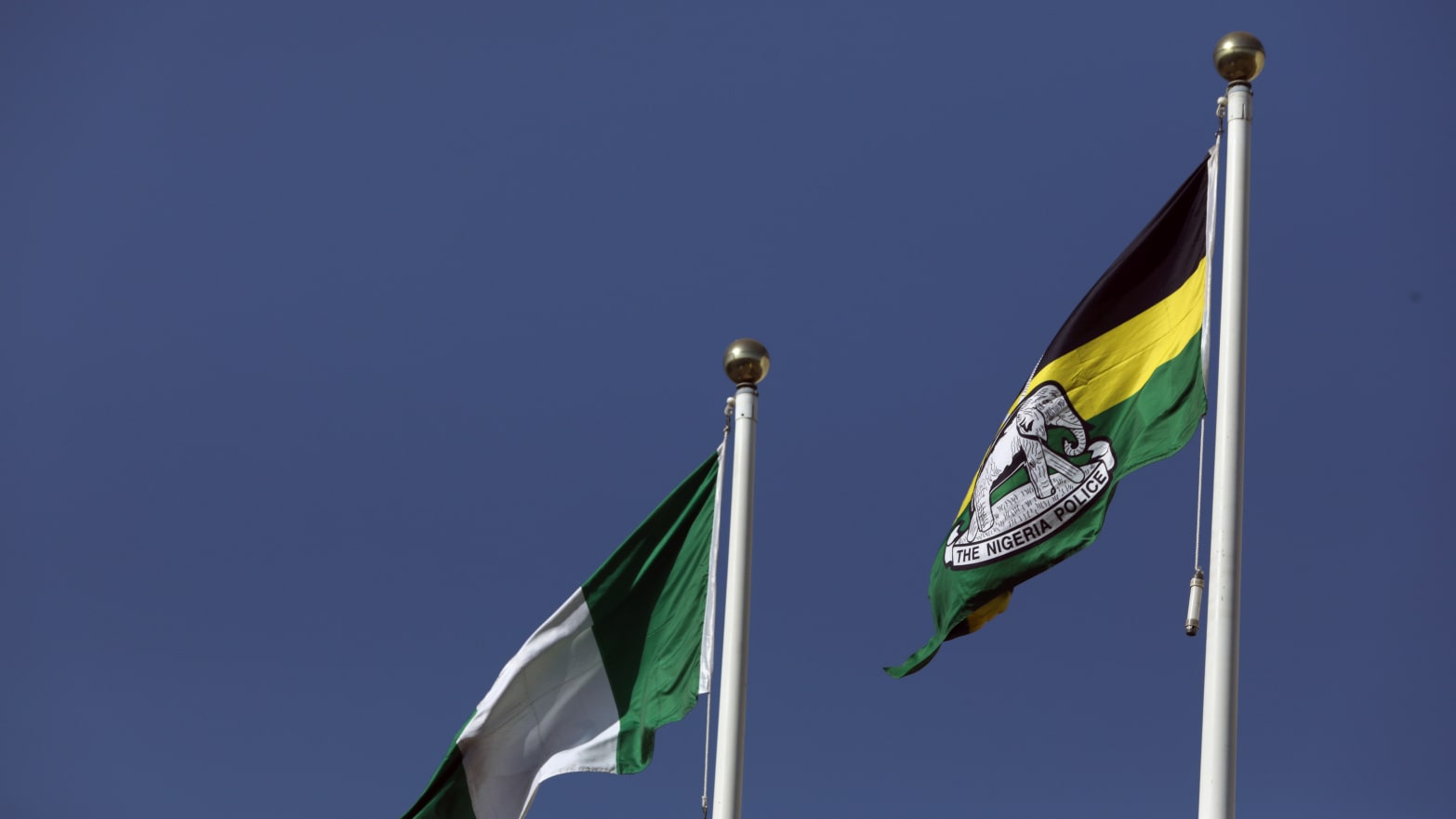The Nigeria police flag flies next to the national flag.