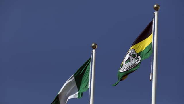 The Nigeria police flag flies next to the national flag.