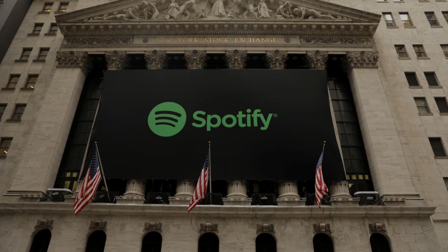 The Spotify logo hangs on the facade of the New York Stock Exchange as the company lists its stock with a direct listing in New York, April 3, 2018.