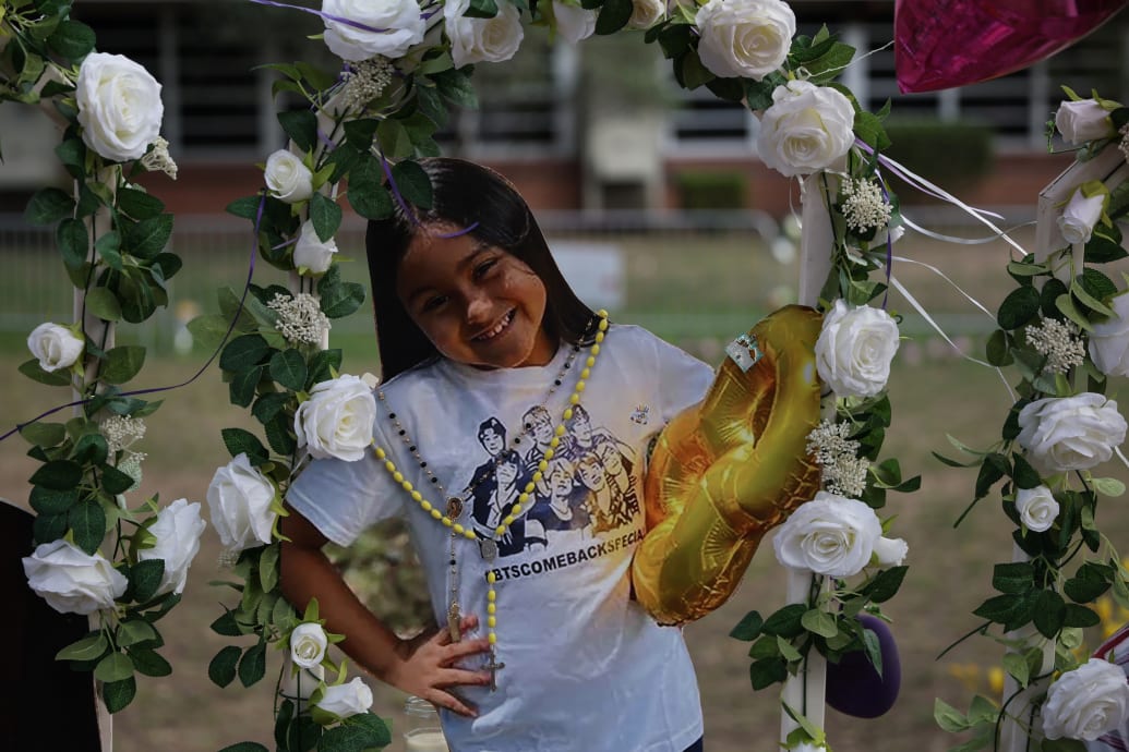 A photo cutout of Amerie Jo Garza shows her smiling at a memorial.
