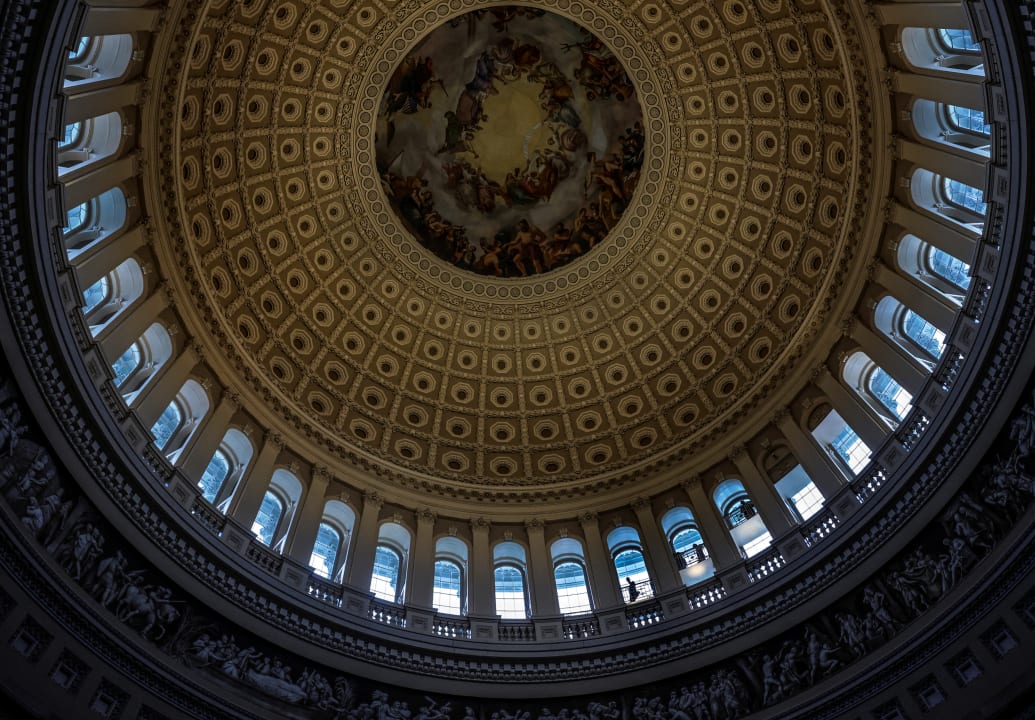 Tourists walk underneath the dome in the U.S. Capitol Rotunda