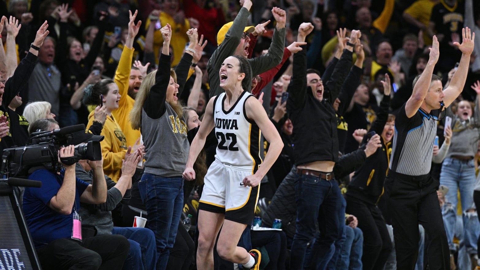 Iowa Hawkeyes guard Caitlin Clark reacts with fans after breaking the NCAA women's all-time scoring record.
