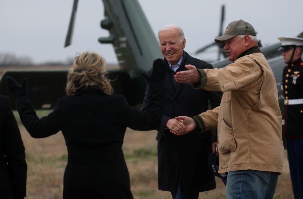 U.S. President Joe Biden is welcomed by Minnesota Governor Tim Walz and Gwen Walz, first lady of Minnesota, as he arrives in Northfield, Minnesota, U.S., November 1, 2023.