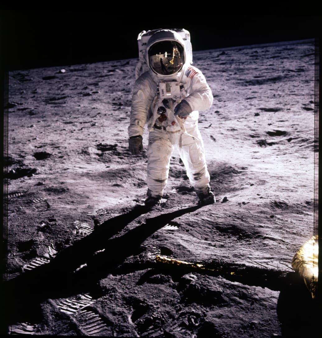 Neil Armstrong on the Moon with Buzz Aldrin in reflection in his visor