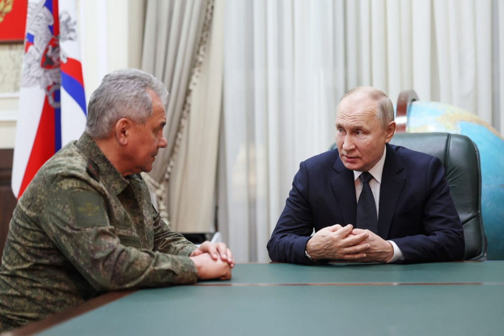 A photograph of Russia's President Vladimir Putin (C) meeting with Russian defense minister Sergei Shoigu (L) in 2023.