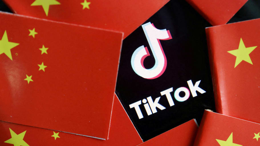 China’s flags are seen near a TikTok logo in this illustration picture taken July 16, 2020. 