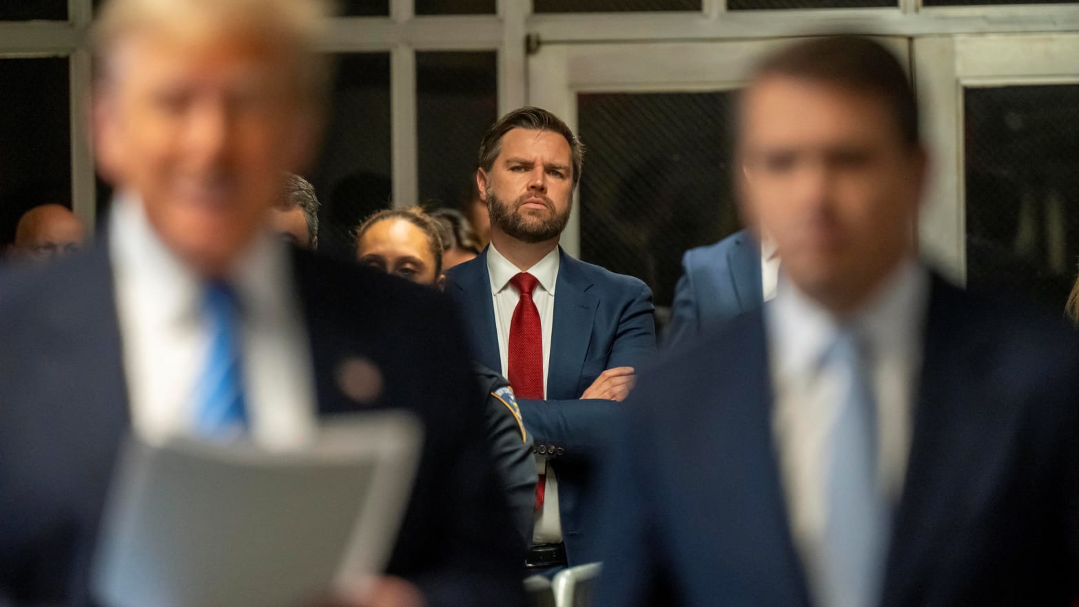 Sen. J.D. Vance (R-OH) stands behind former President Donald Trump.