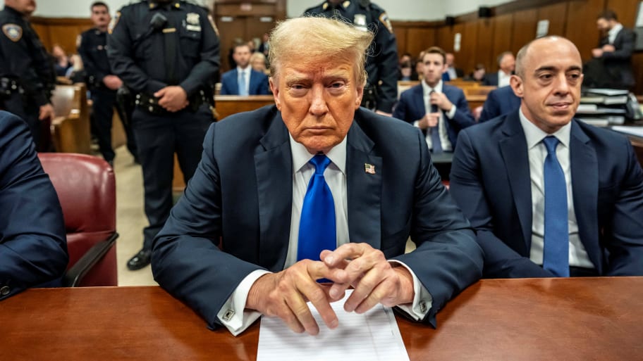 Donald Trump stares forward while twiddling his fingers in court.