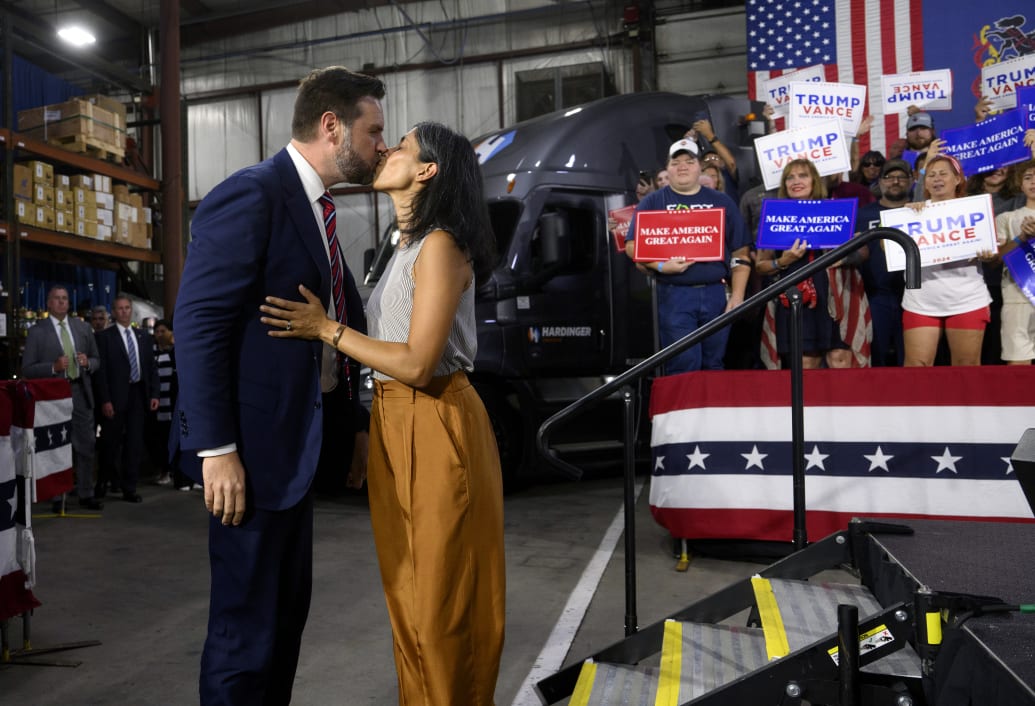 Republican vice presidential nominee J.D. Vance walks on stage with his wife, Usha, before speaking at a rally at trucking company in Erie, Pennsylvania.