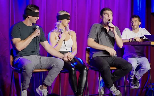 Two blindfolded contestants participate in one of UpDating's shows. 