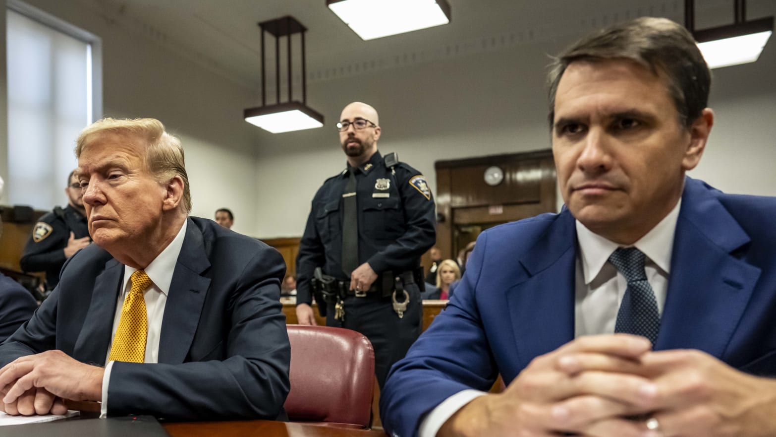 Former U.S. President Donald Trump appears in court with attorneys Emil Bove (L) and Todd Blanche (R)  for his trial for allegedly covering up hush money payments at Manhattan Criminal Court on May 21, 2024 in New York City. 
