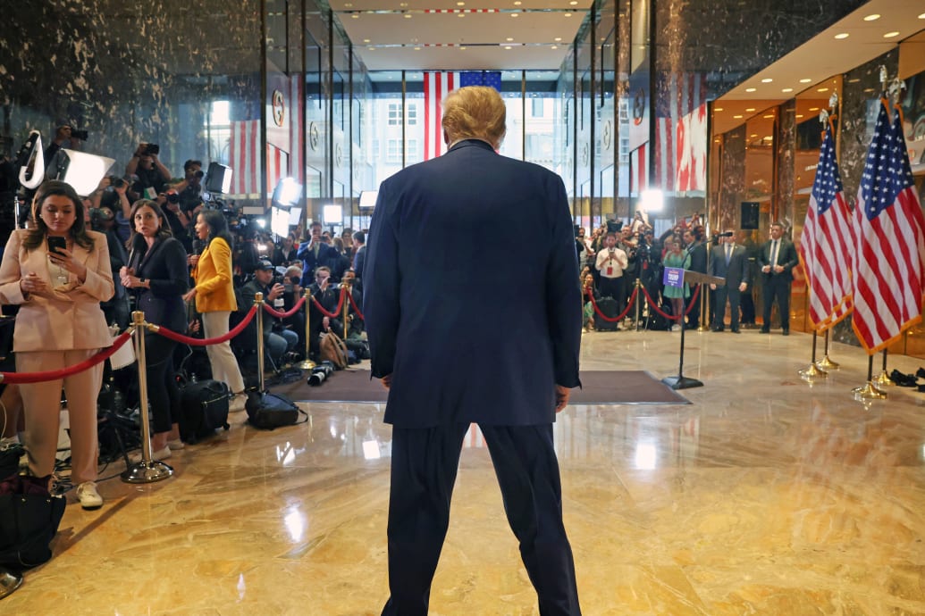 The view of Donald Trump's back as he gives a news conference at Trump Tower. 
