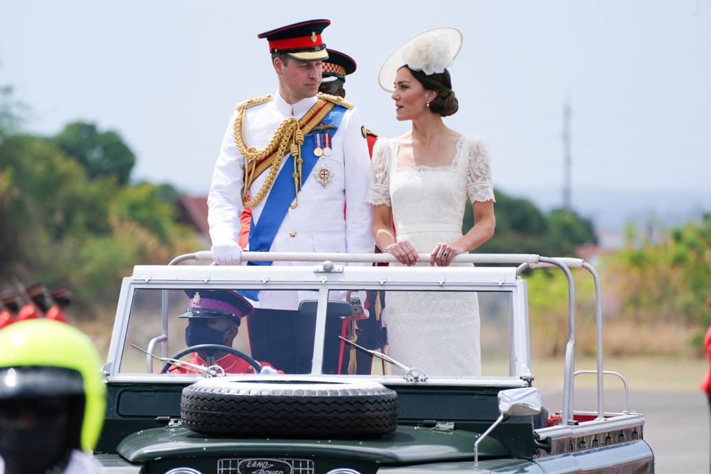 Britain's Prince William and Catherine, Duchess of Cambridge ride in a vintage Land Rover as they attend a commissioning parade for The Jamaica Defence Force, on the sixth day of their tour of the Caribbean, in Kingston, Jamaica, March 24, 2022.
