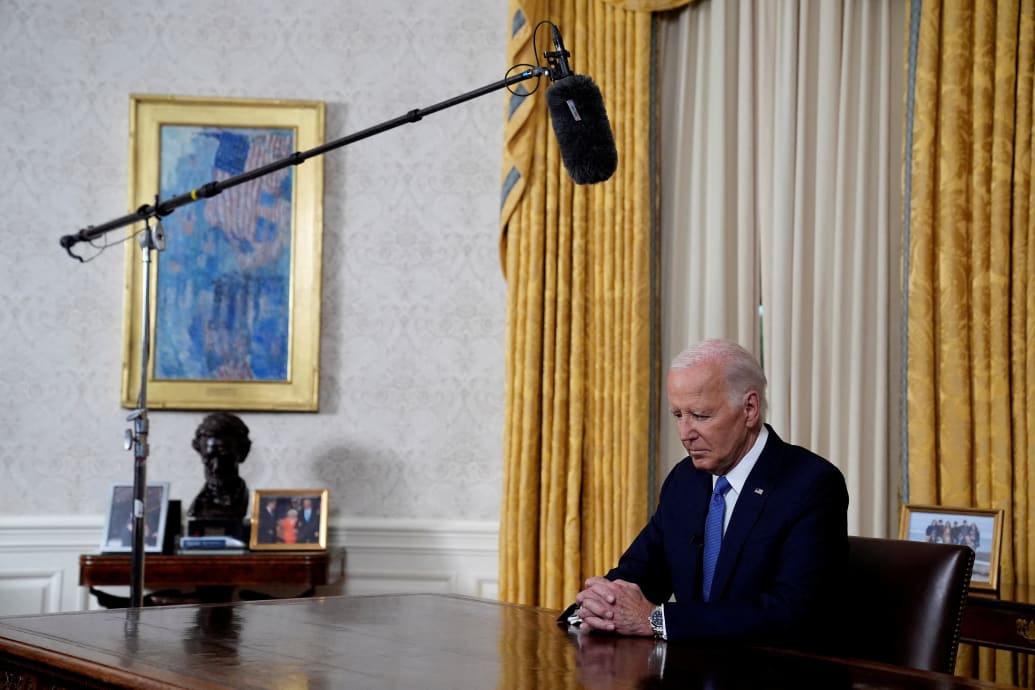 Biden at the Resolute desk looking down