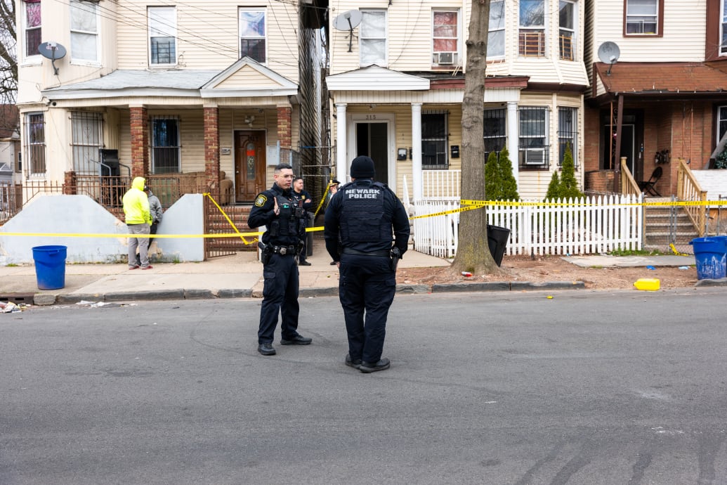 A photo of Newark, New Jersey residents and police gathering outside of homes that were structurally damaged and had to be evacuated after the area experienced a 4.8 magnitude earthquake.