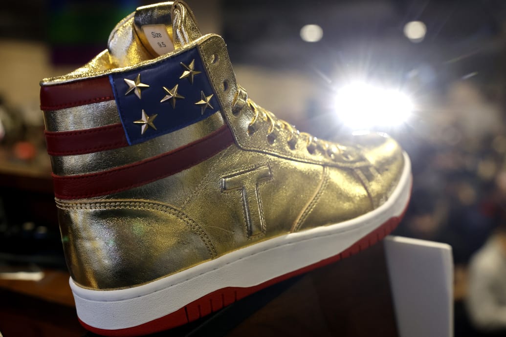 The Gold Trump shoes that are being sold at Sneaker Con