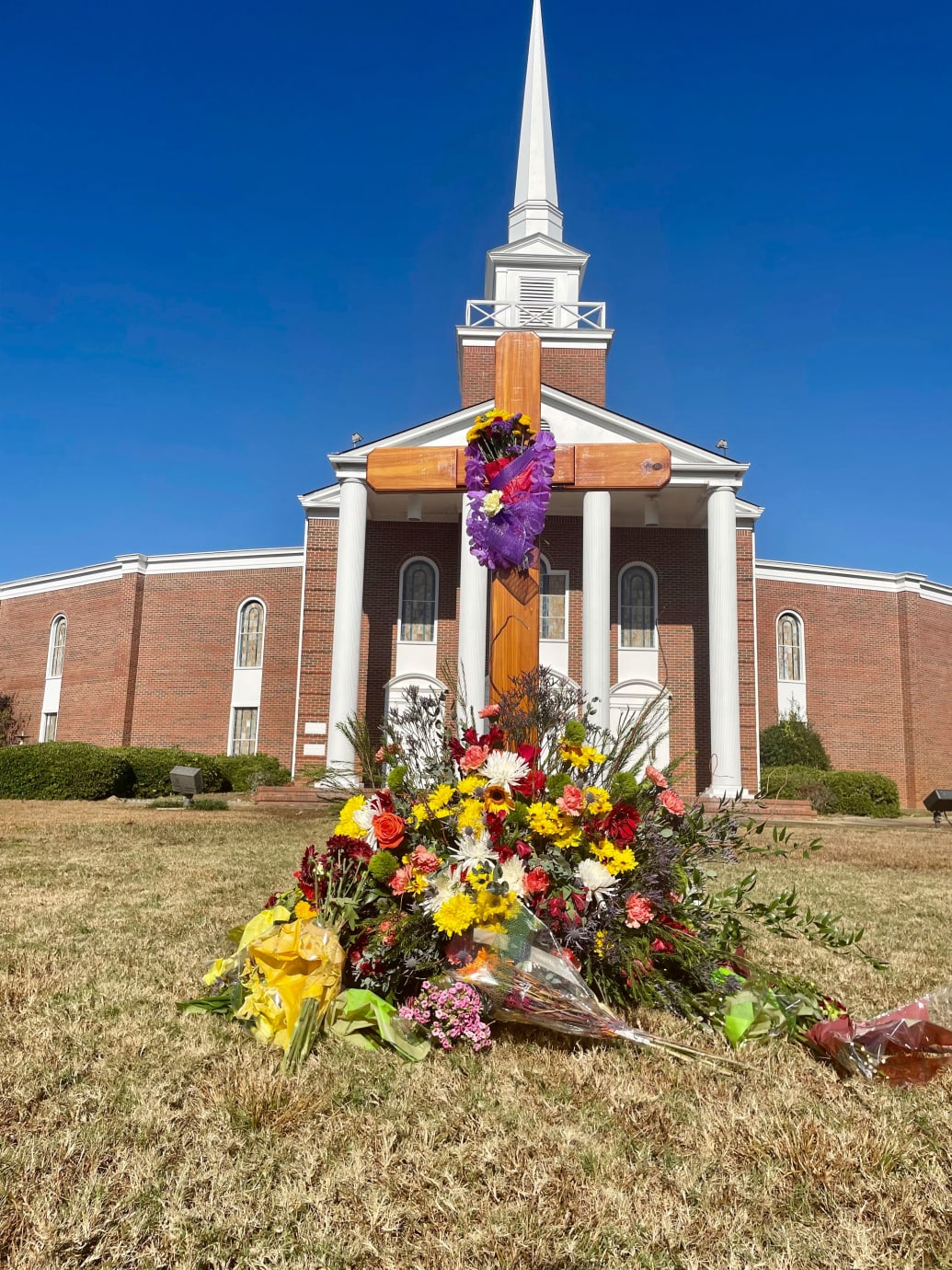A photograph of flowers sitting in a memorial to Bubba Copeland outside First Baptist Church in Phenix City, Ala., on Nov. 5, 2023.
