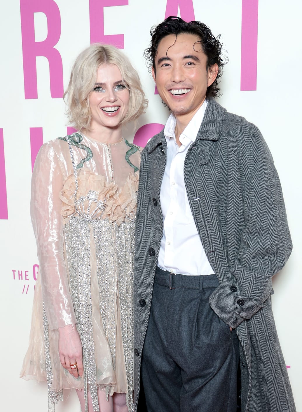 A photo of  Lucy Boynton and Justin H Min on a step and repeat
