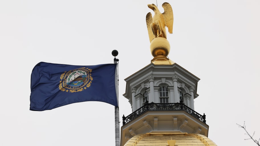 The New Hampshire state flag and state capitol building.