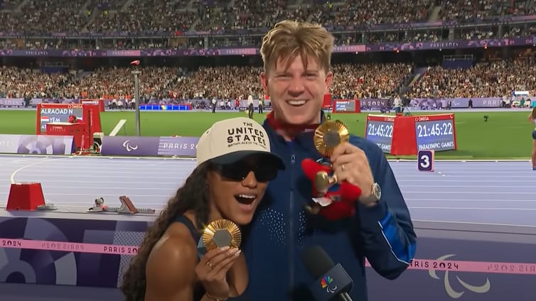 Tara Davis-Woodhall and Hunter Woodhall show off their matching gold medals at the 2024 Paralymic Games in Paris on September 6, 2024.