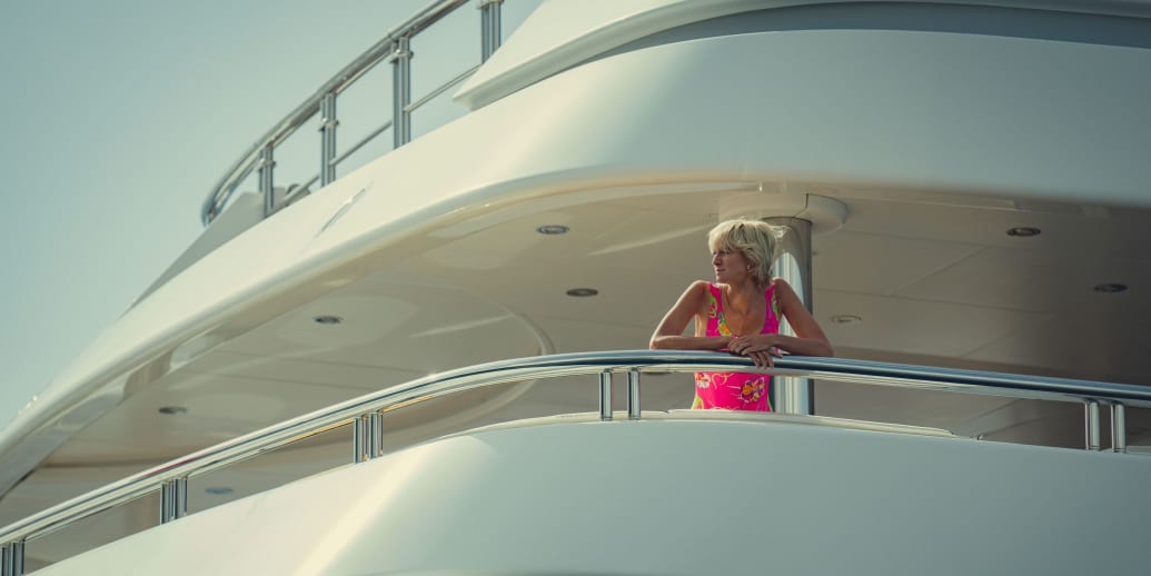 A still from The Crown's final season, showing Princess Diana in a neon print bathing suit.