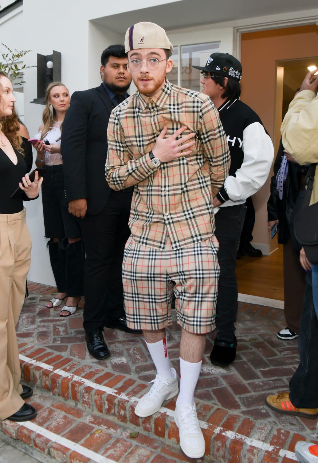Photograph of Angus Cloud attending an event in all Burberry print.