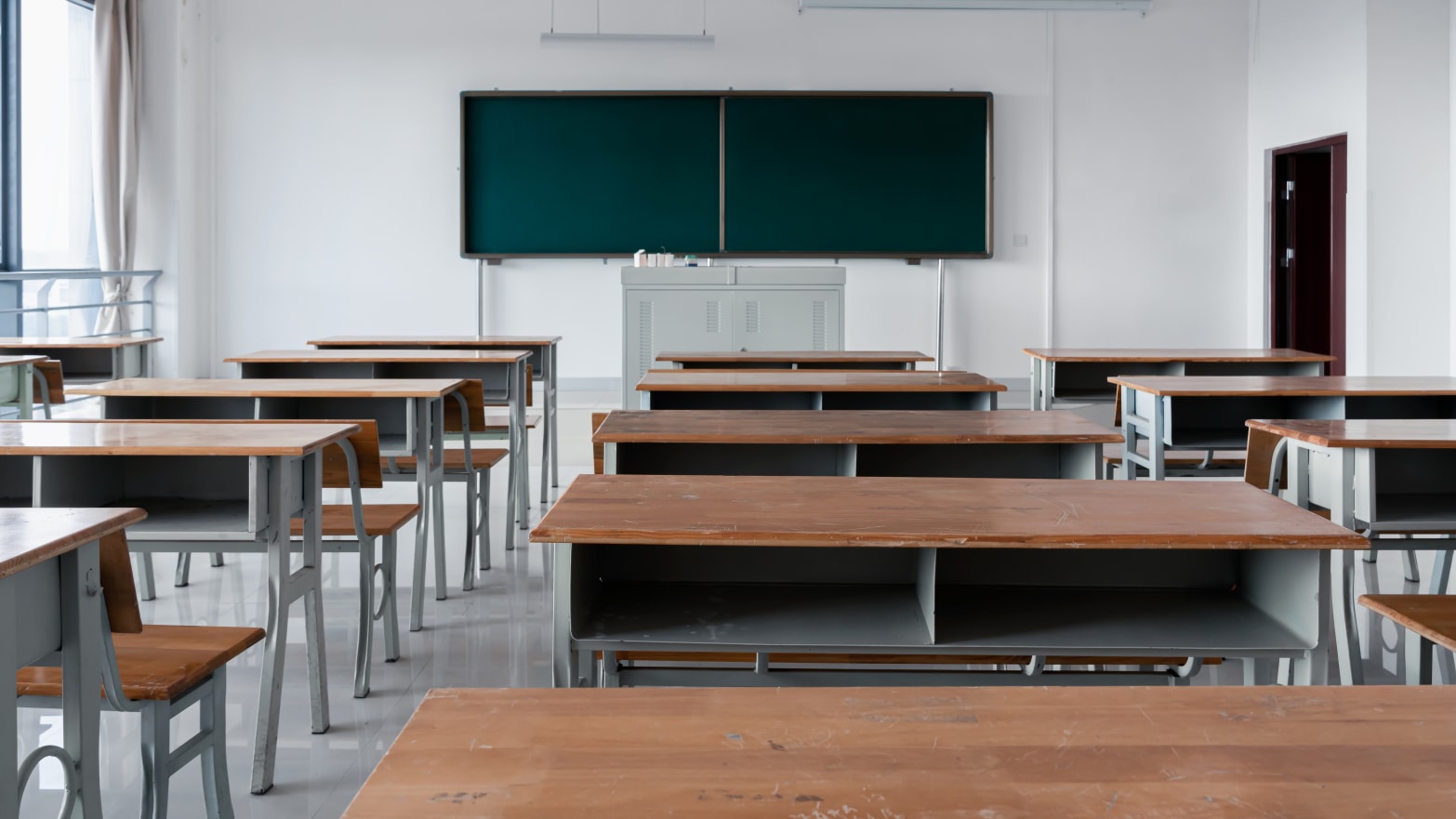 Classrooms with desks, chairs, podiums and blackboards.