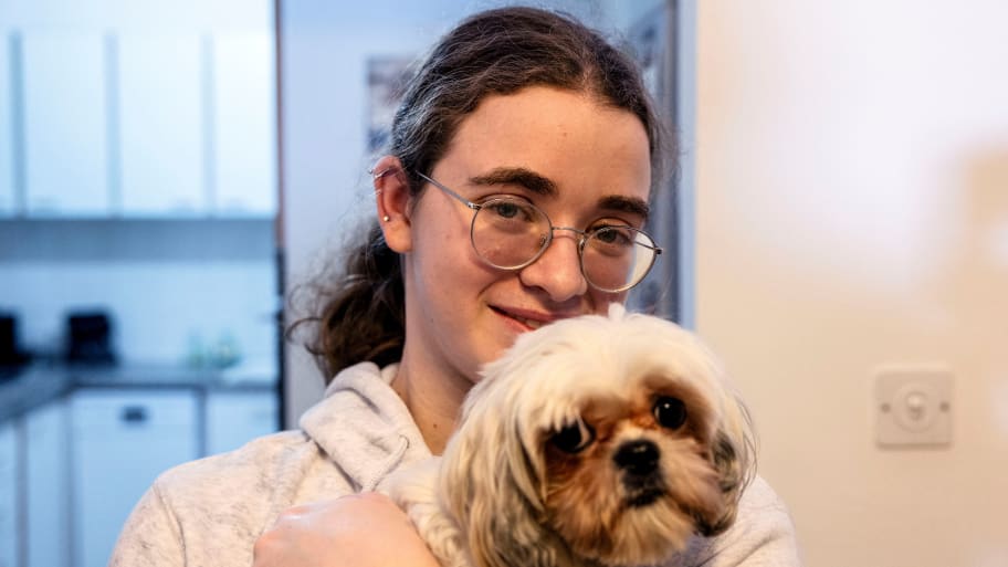Mia Leimberg, 17, released from captivity after being taken hostage by the Palestinian Islamist group Hamas in the Gaza Strip with her mother Gabriela and her dog Bella, holds the dog in her arms at their home in Jerusalem