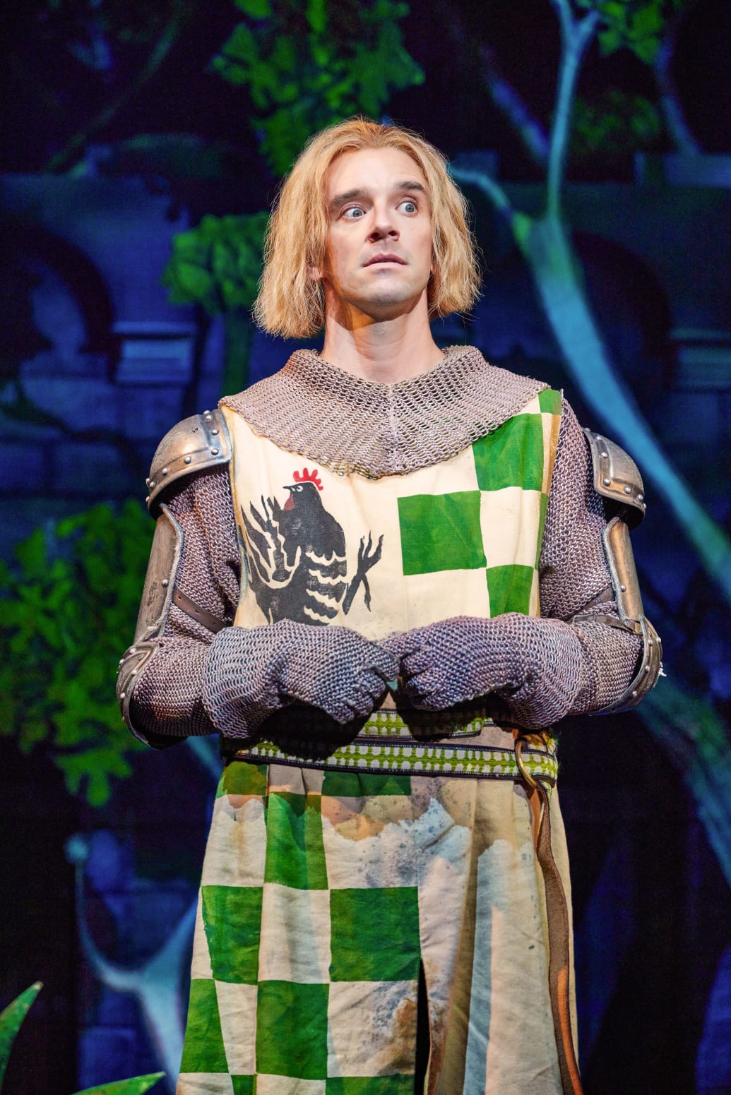 Michael Urie dressed in a green and white coat of armor in a picture from the Broadway musical ‘Spamalot’