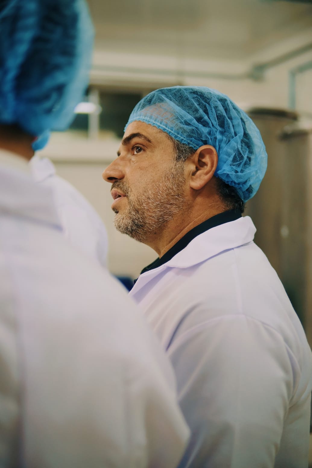 A picture of Bill Panagiotakopoulos inside of a processing plant