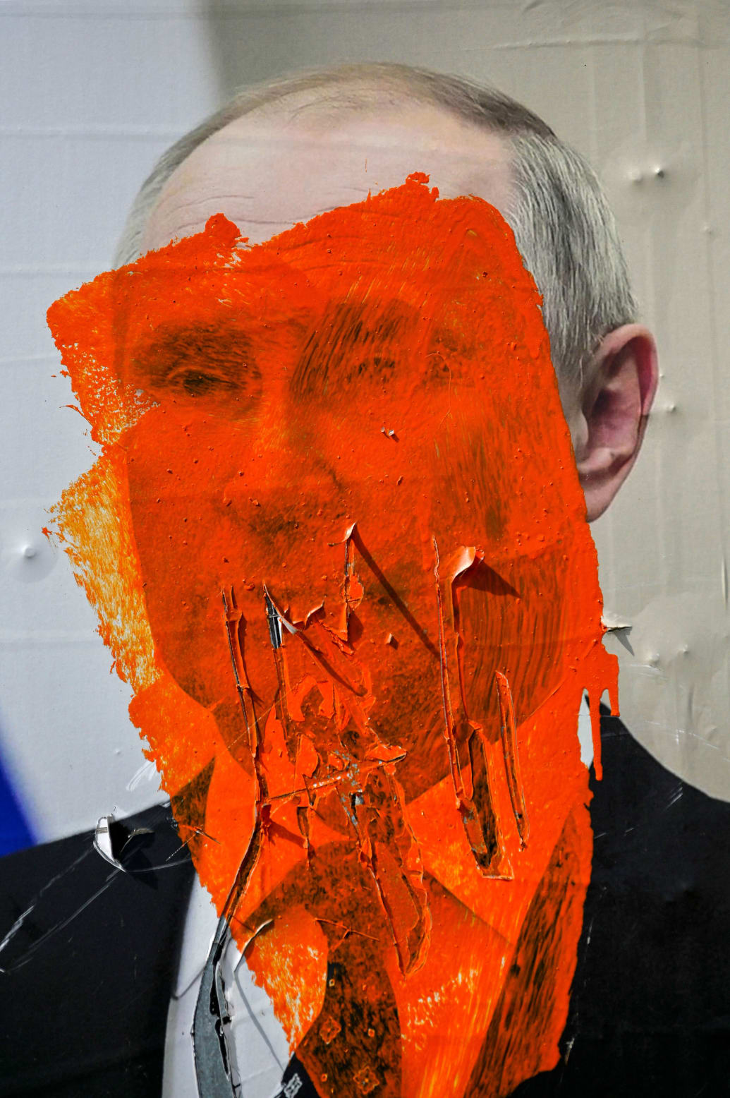 A picture of Vladimir Putin that’s been painted over and ripped up.