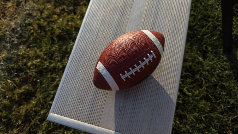 A football rests on the bench