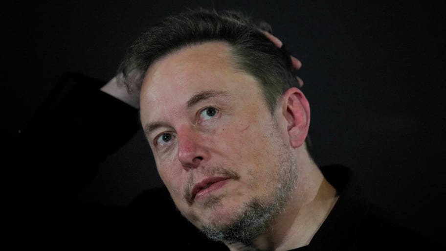 Elon Musk reacts during an in-conversation event with British Prime Minister Rishi Sunak in London