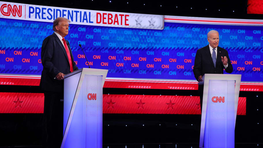 Joe Biden and Donald Trump debate each other on stage.